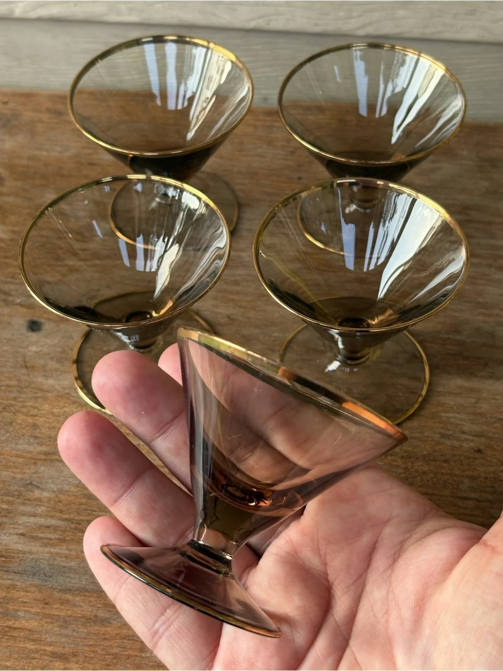 Art Deco decanter set features smoky purple glass adorned with a gold floral